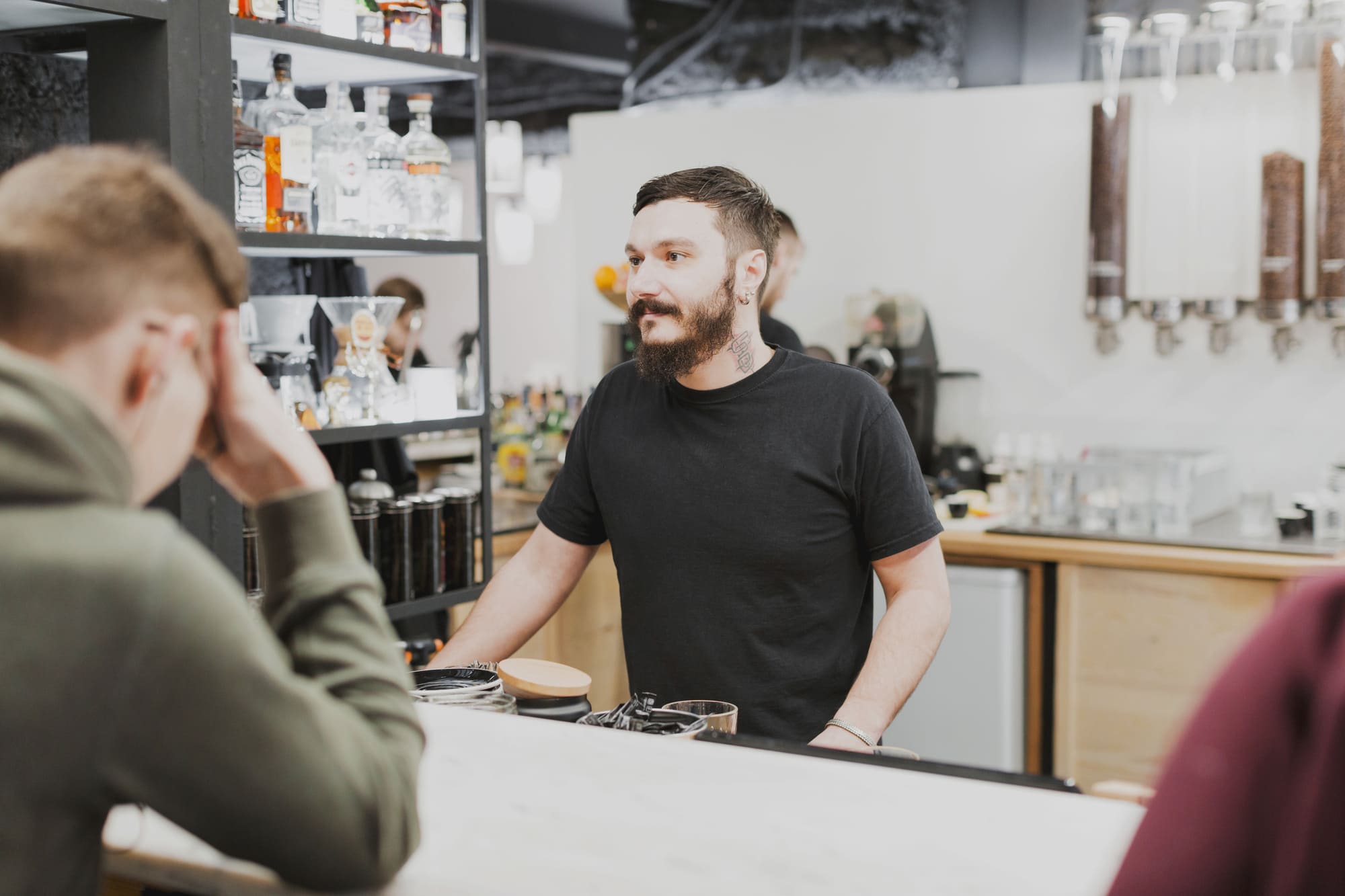barmedewerker is klanten aan het helpen